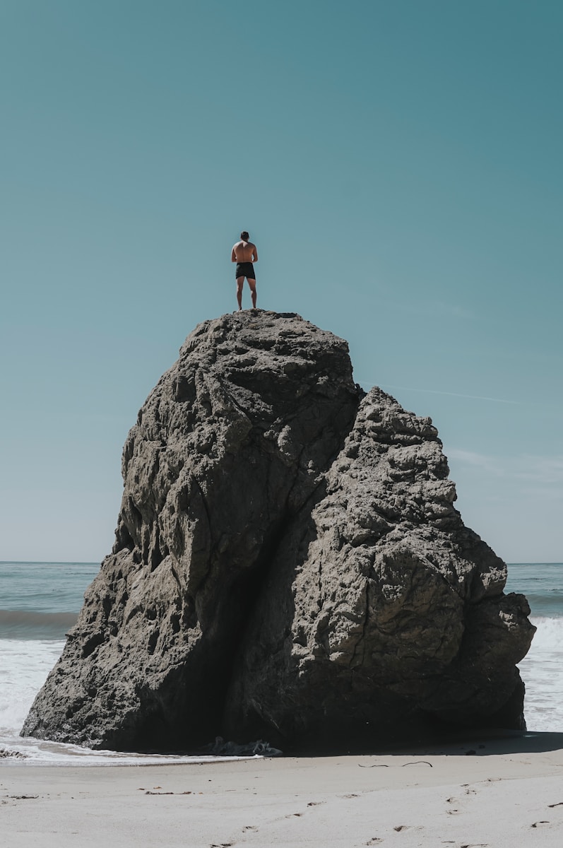 person standing at rock formation
